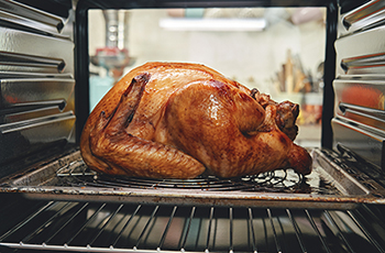 Photo of a turkey cooking in an oven