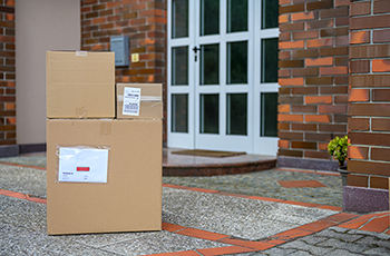 Photo of packages sitting on the front step of a residence