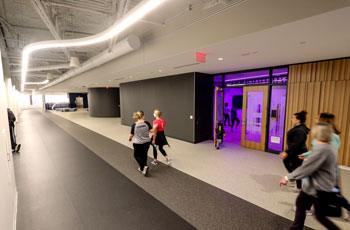 People walking around the indoor track at the Plymouth Community Center