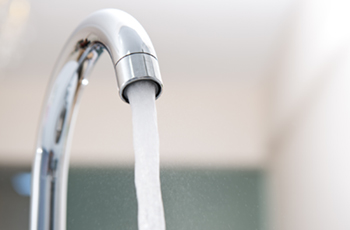 Photo of a running water faucet