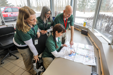 CERT members gathered around a map of Plymouth