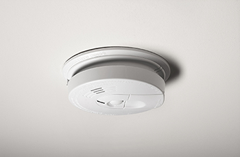 Photo of a smoke detector on a ceiling