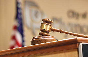 Closeup of a gavel in the Plymouth City Council chambers