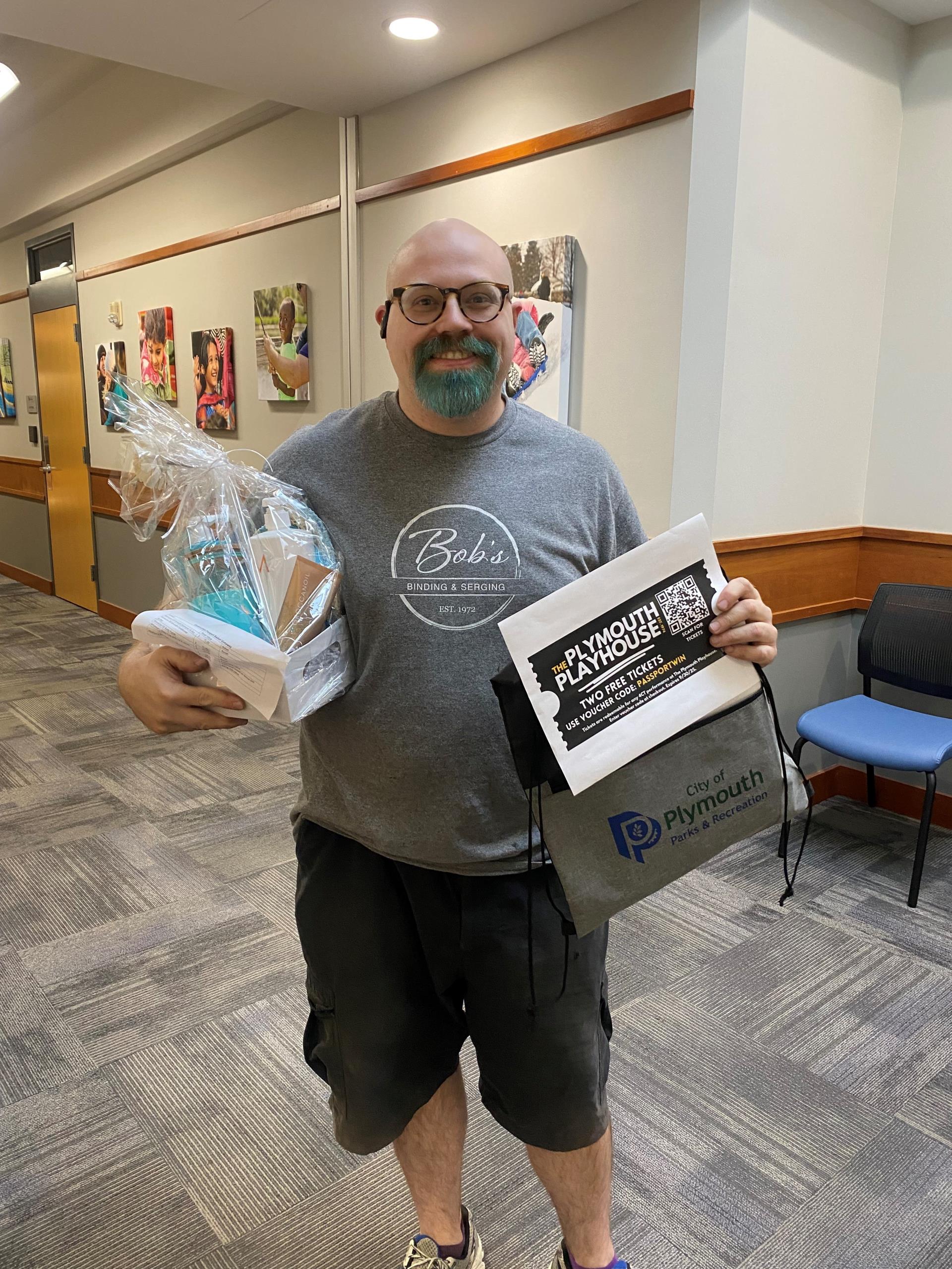 Photo of Chris, with his prize basket from the passport program worth $250