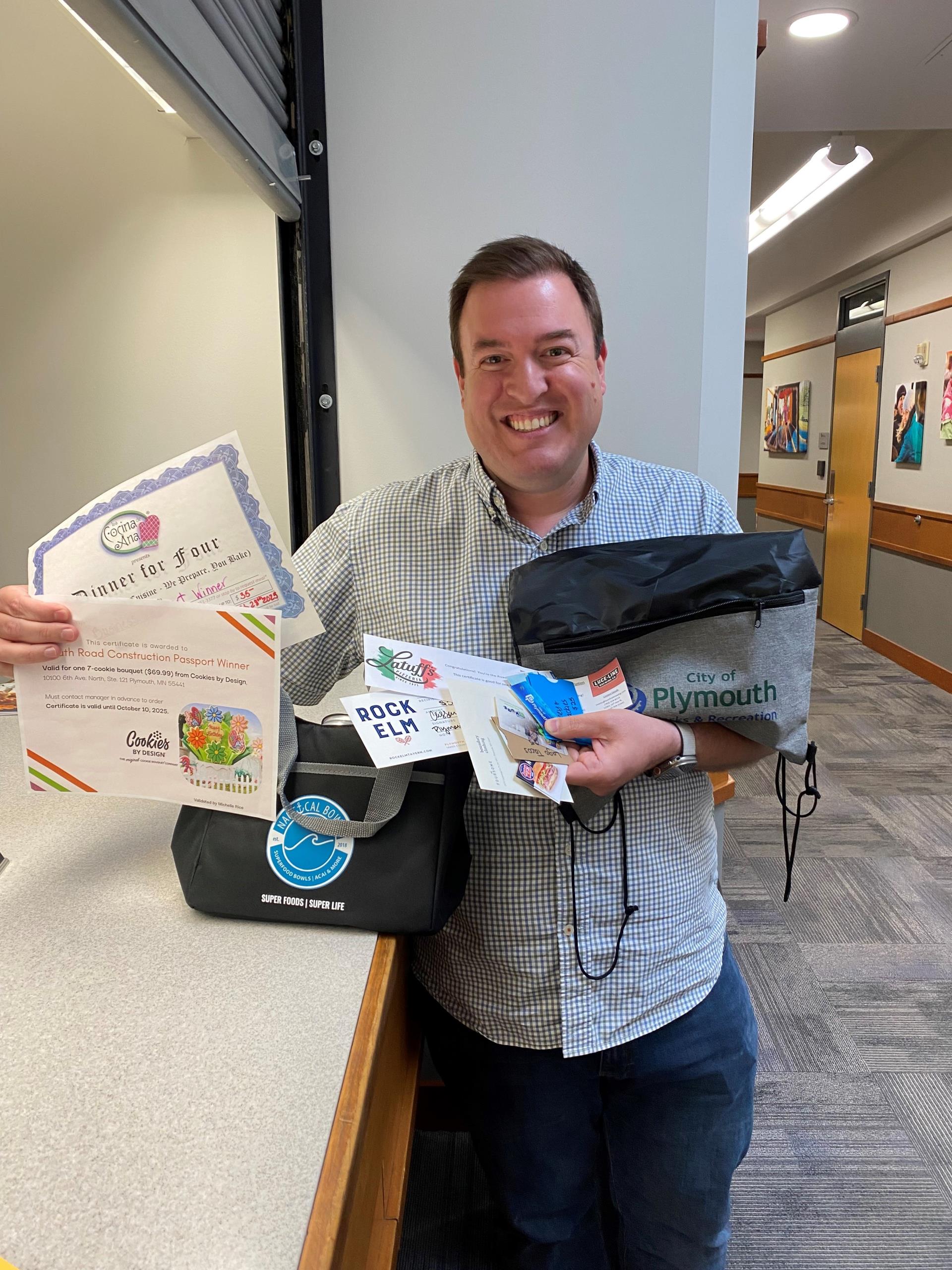 Photo of Josh, with his prize basket from the passport program worth $500