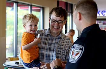 Plymouth police officer interacting with a family