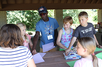 Teen volunteering with children in Plymouth recreation programs