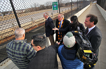 State and local lawmakers tour the existing County Road 9 bridge over I-494 as part of the city's advocacy efforts