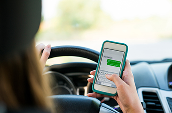 Teenage girl texting while driving