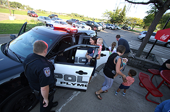 Children exploring a Plymouth Police Squad during a Cones with Cops event