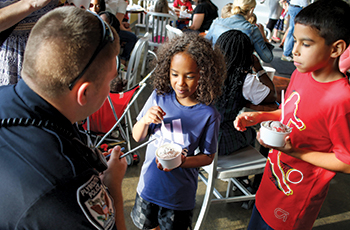 Children enjoying ice cream during the Plymouth Police Department's Cones with Cops event