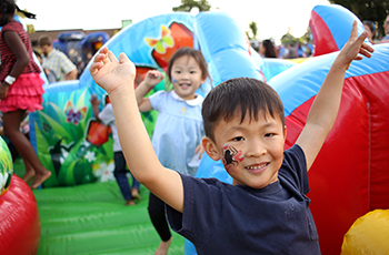 Children jumping on inflatables at Kids Fest in Plymouth