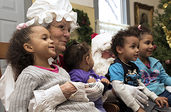 Kids sitting on Santa's lap at Plymouth's Old Fashioned Christmas event