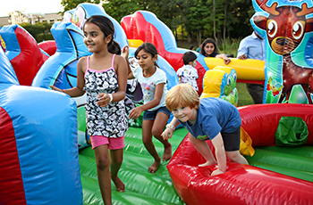 Kids playing on inflatables at Kids Fest