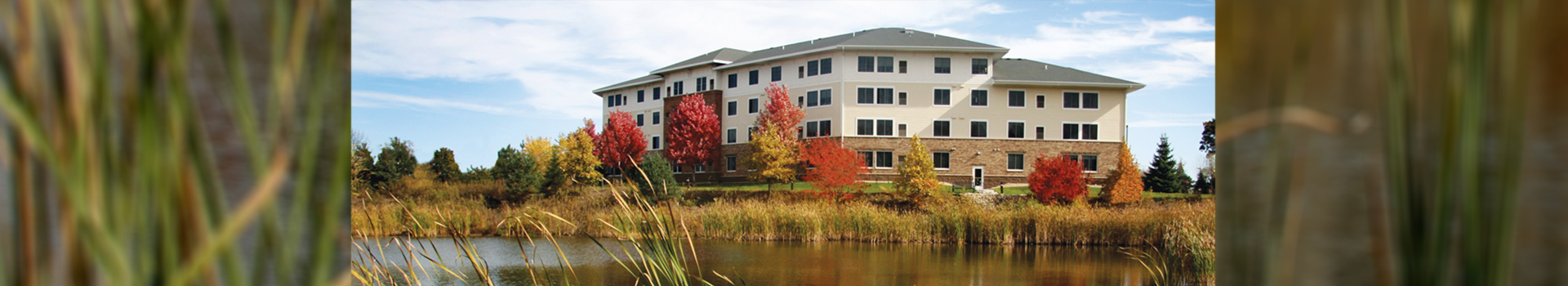 Vicksburg Crossing building nearby a picturesque pond and nature