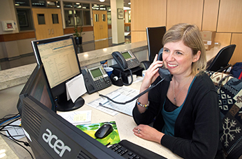 City of Plymouth staff member smiling and answering the phone