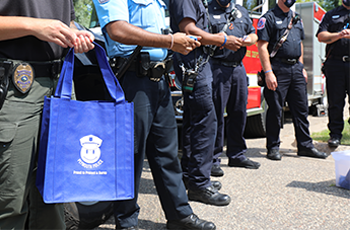 Police officer holding a bag of giveaways