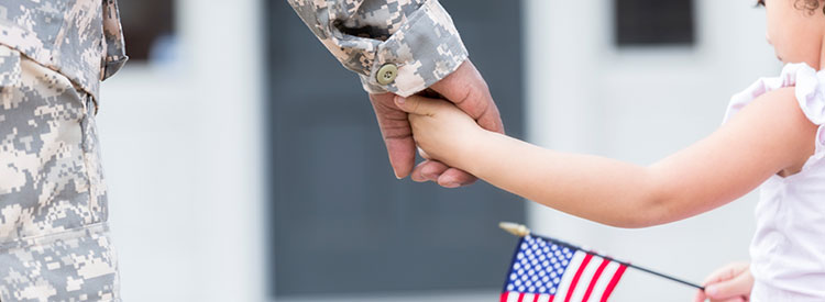 Veteran and child holding hands