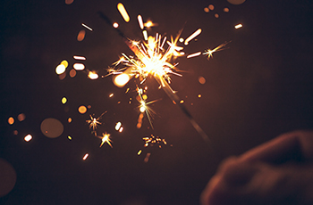 Closeup of a hand holding a sparkler