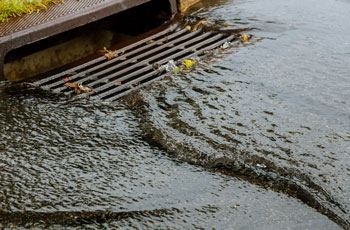 Image of rain water running through a storm drain