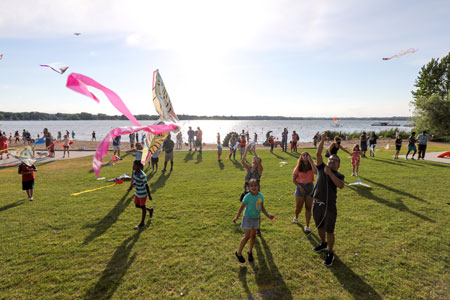 Plymouth community members flying kites at Medicine Lake