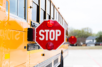 Closeup of a school bus with stop sign extended